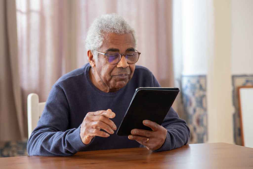 Old man using digital tablet
